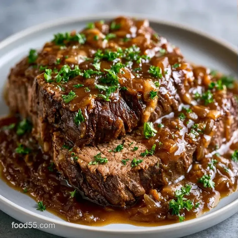 A white ceramic bowl filled with slow-cooked beef and root vegetables, garnished with a sprig of fresh green parsley.